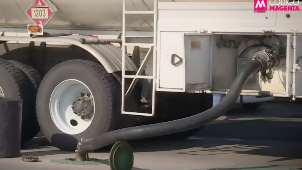 Fuel Tanker with a Large Black Hose Connected to a Ground Fuel Valve, Preparing for Refueling at a Station. - La Sultana Informa